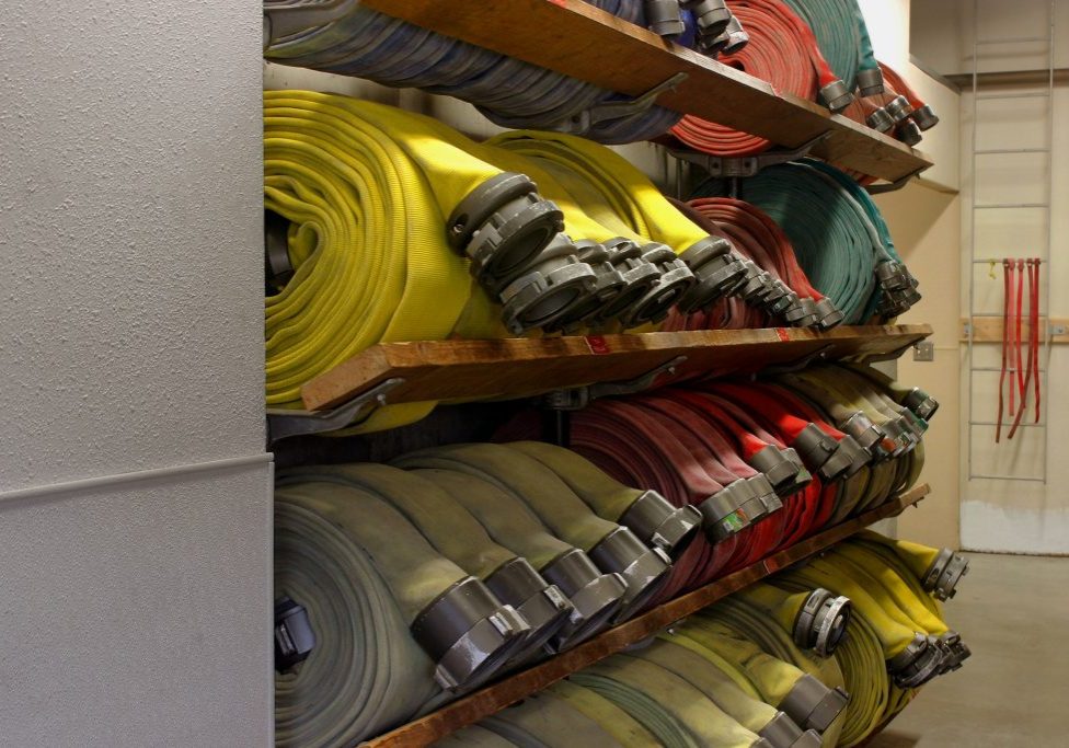 Fire department equipment. Rows of fire fighting hoses.